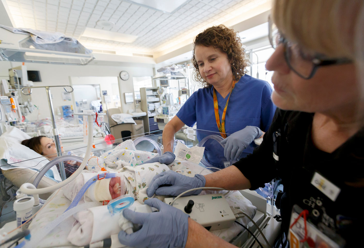 Doctor Cindy McEvoy working with a baby in the NICU