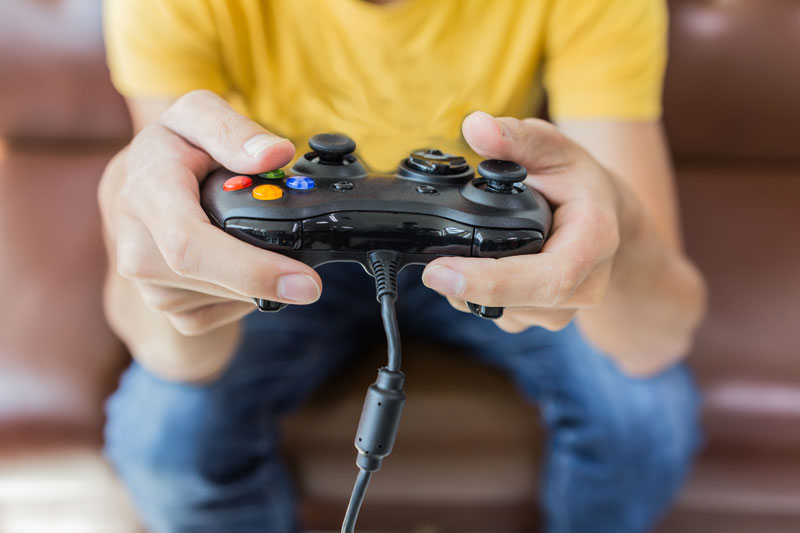 Teen holding video game controller