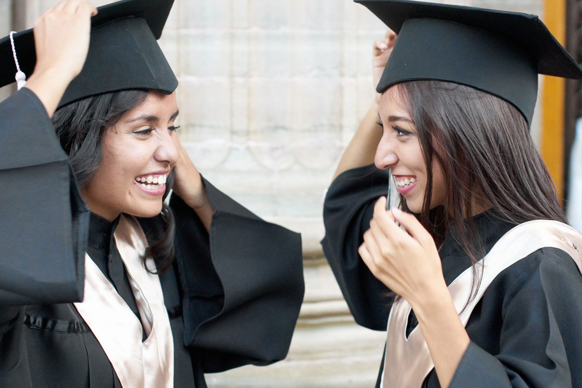 Two young women in graduation cap and gown