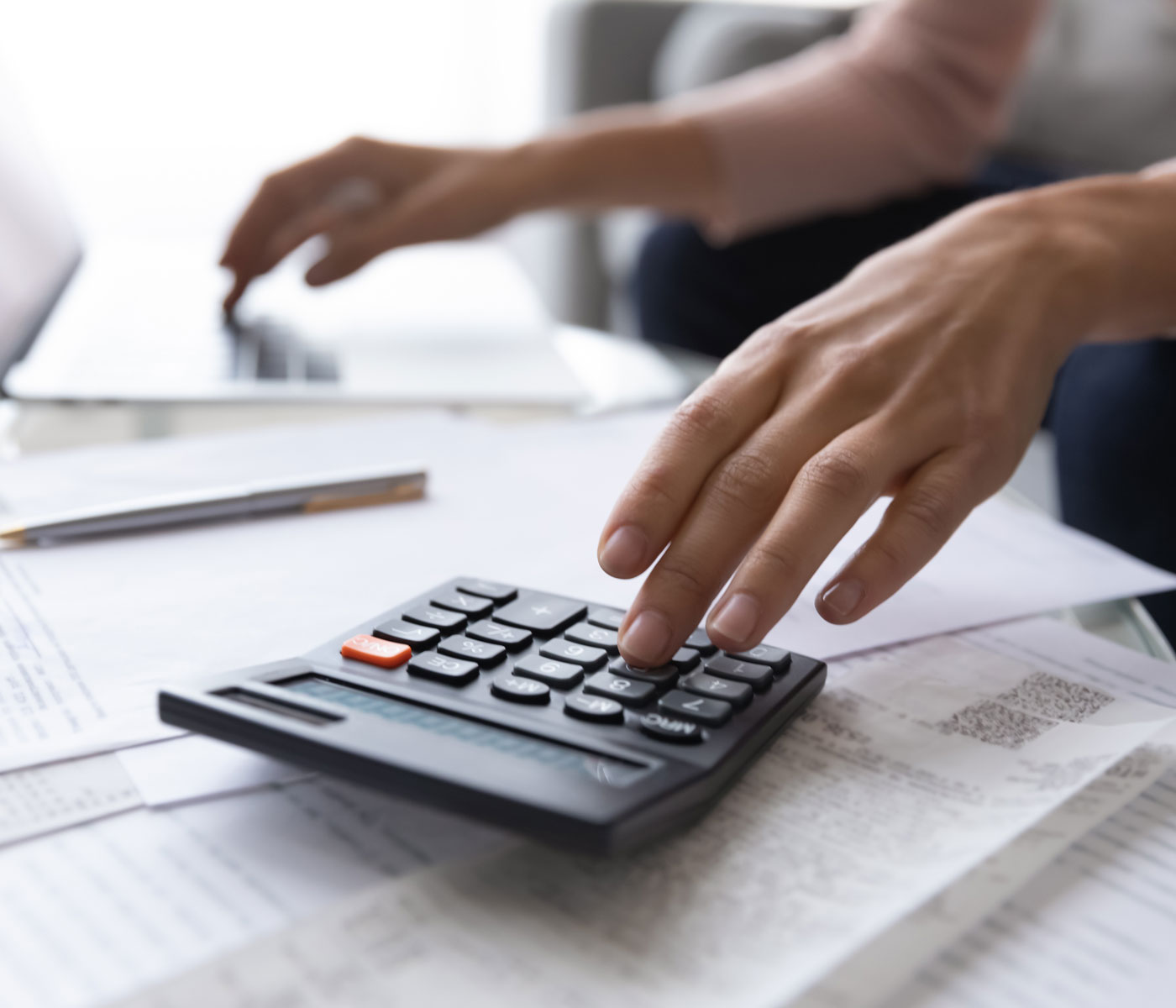 A person adding up donations on a calculator