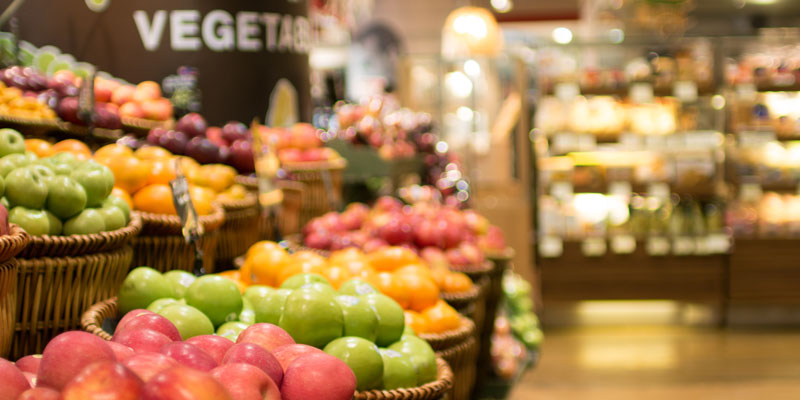 bins of colorful apples in a grocery store