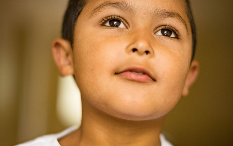 Young Boy Staring with Hopeful Expression
