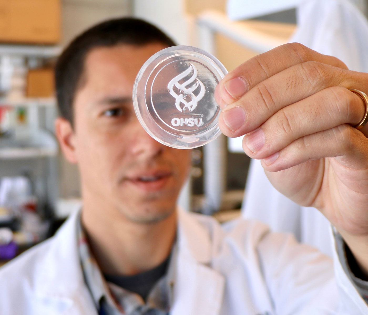 Researcher shows an engineered material that replicates human bone tissue in the shape of the OHSU logo