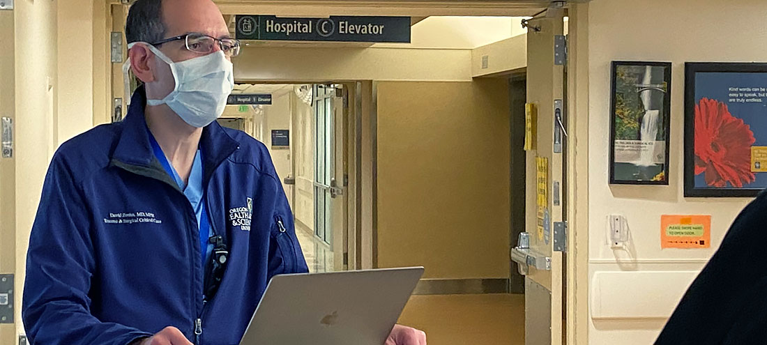 David Zonies works at a laptop in the hospital