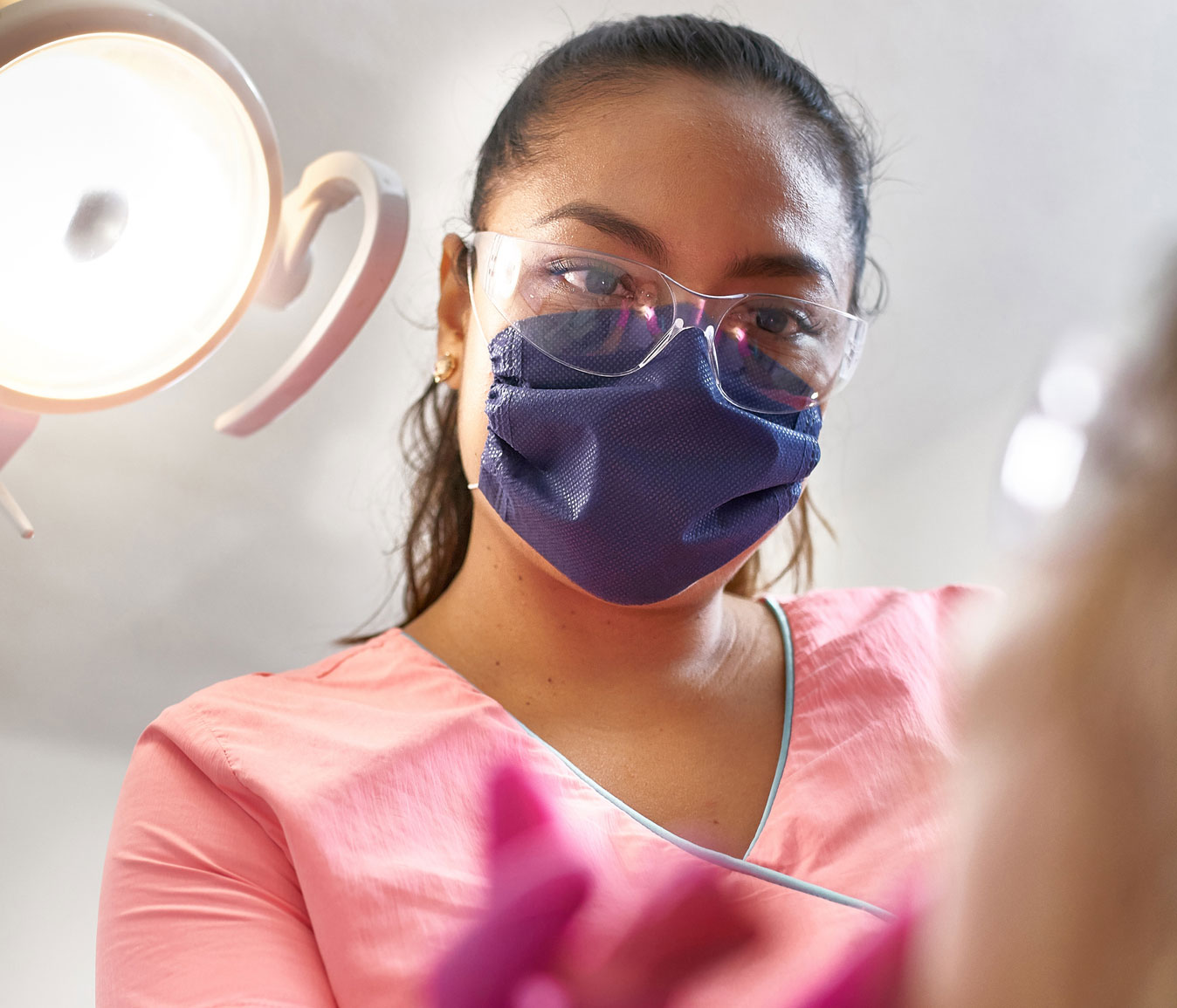 dentist wearing mask looking at patient