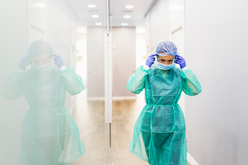 Stock photo of doctor wearing protective mask in the hospital. She is wearing sterile medical protection clothes.