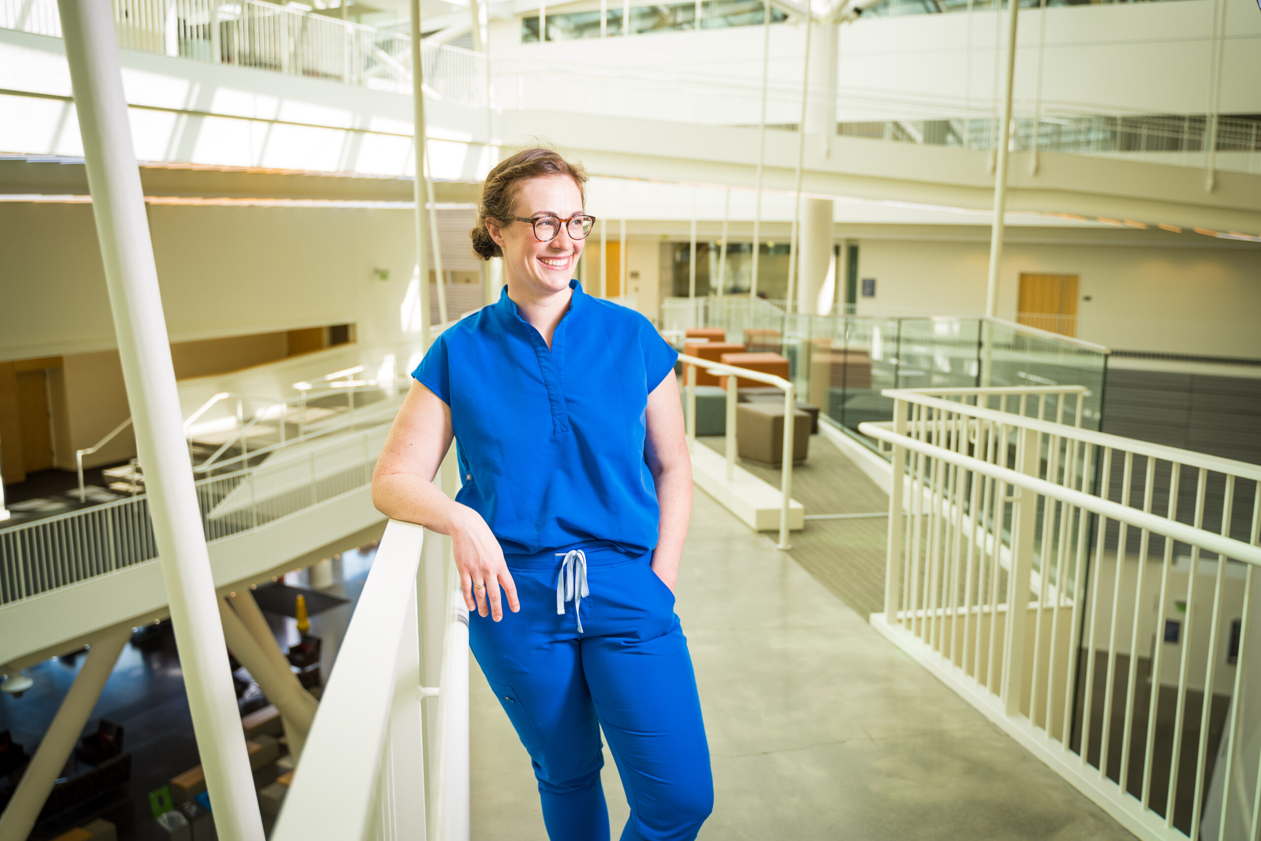 Dr. Alayna Schoblaske leans against railing in Robertson Life Sciences Building