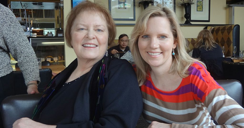 Two women smiling at a restaurant