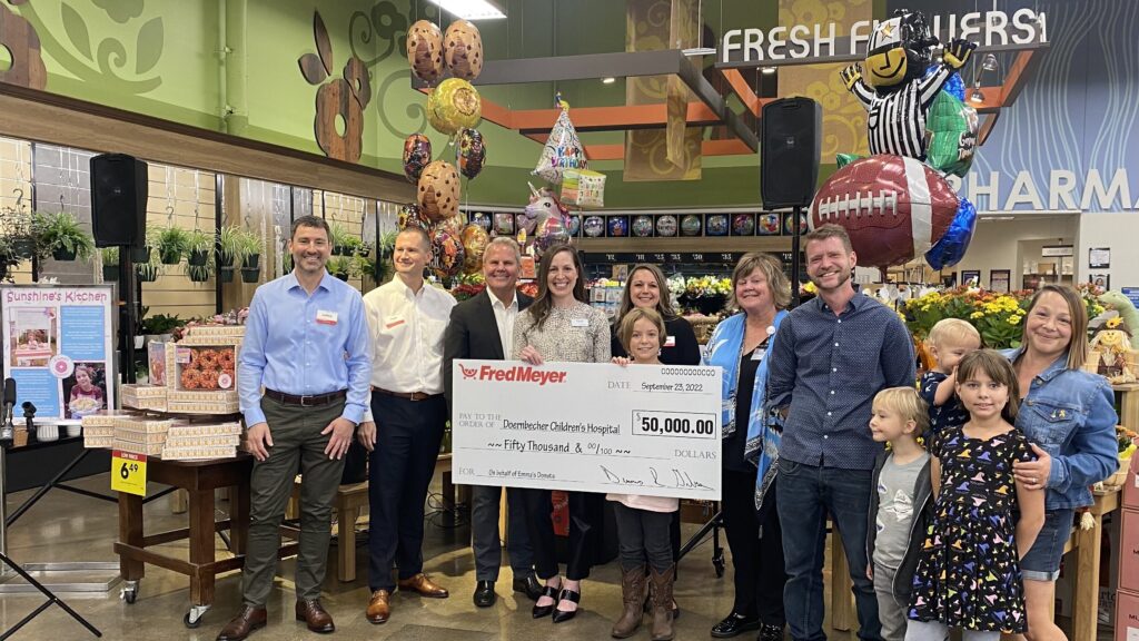 Representatives from Fred Meyer and the Cranston family present check to OHSU Doernbecher Children's Hospital Director of Community Programs, Cassady Naveraz at the Hollywood Fred Meyer. 