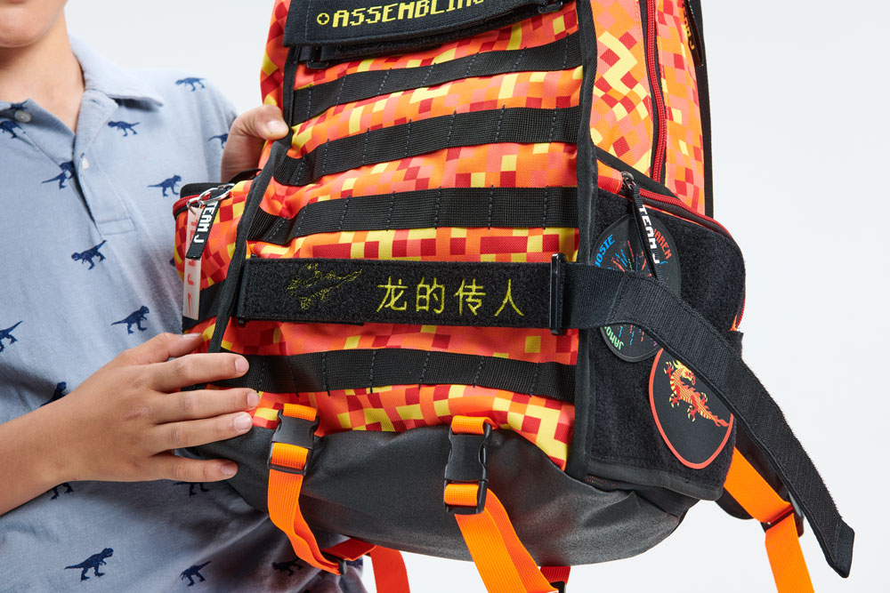 Details of Jaren's backpack in black with orange, red and yellow