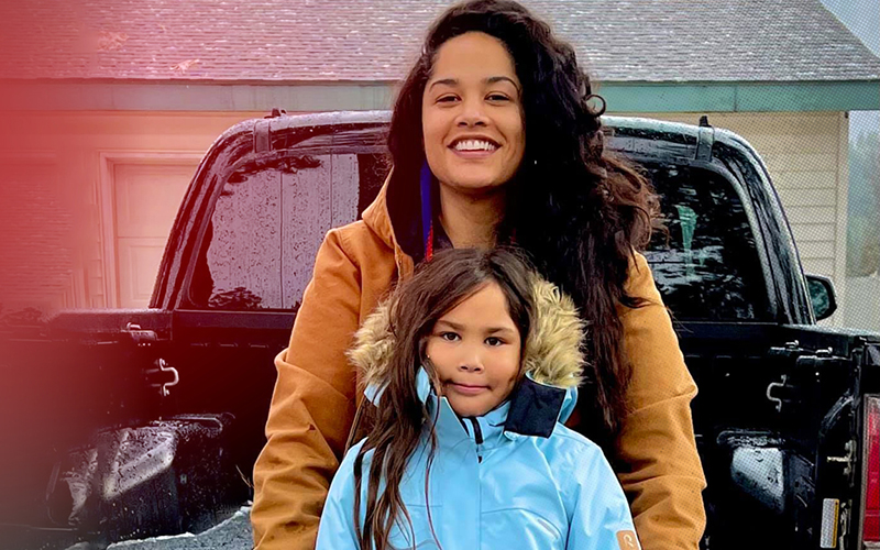 Coley and her mom lean against a pickup truck