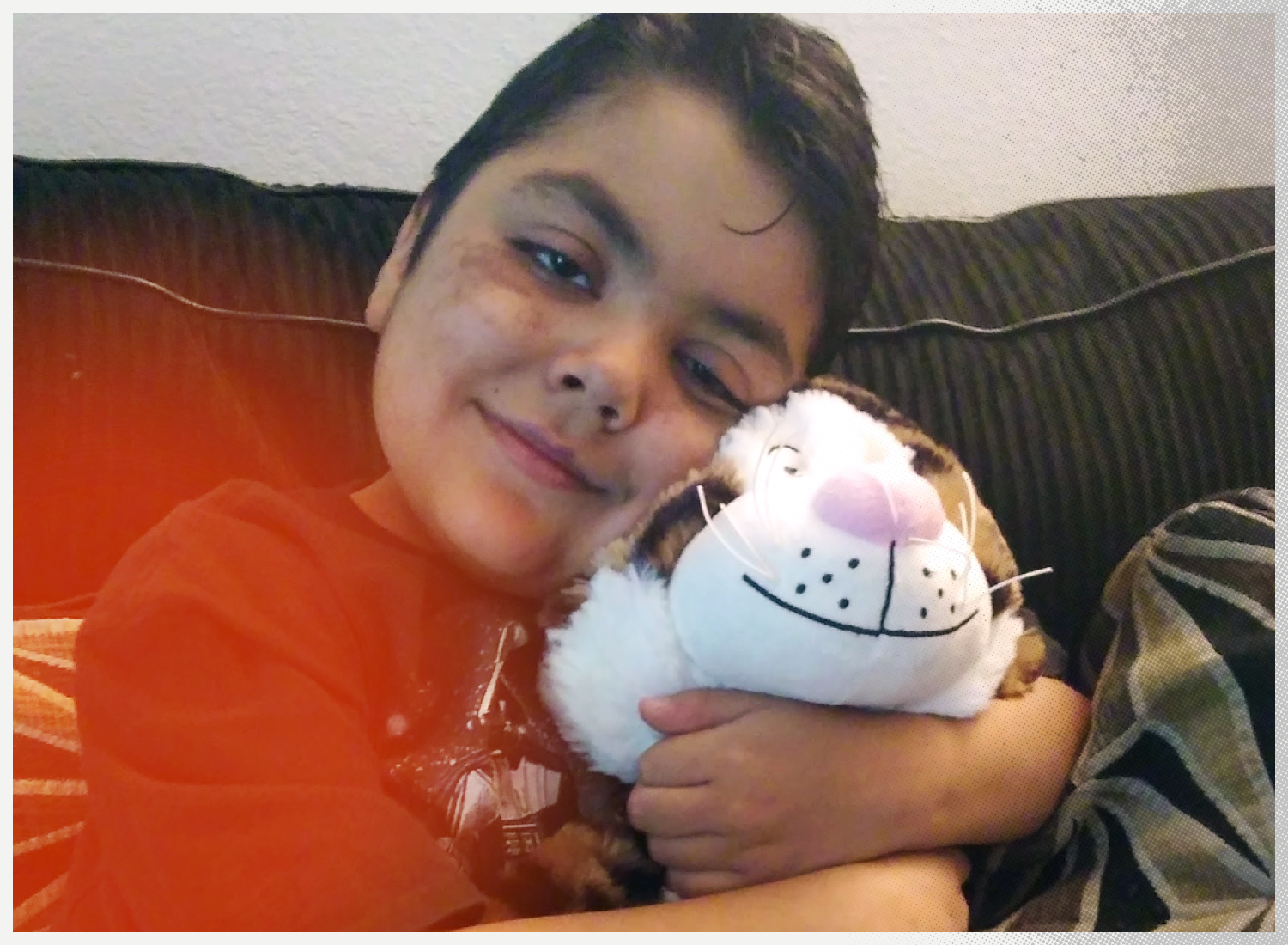 Dario hugs his stuffed animal