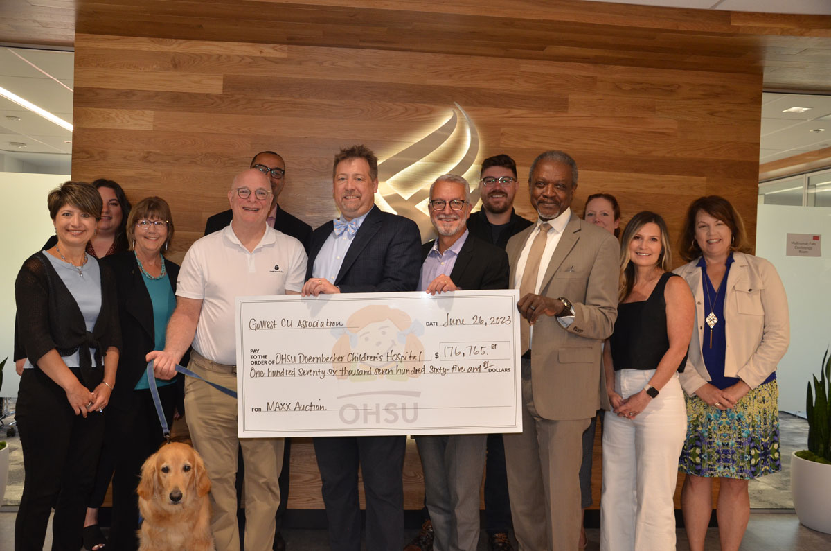 Members of Credit Unions for Kids hold a giant check from Go West Credit Union