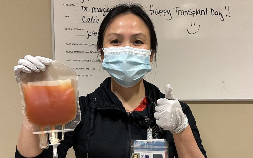 Kathie Phan holds a bag of blood platelets for a bone marrow transplant