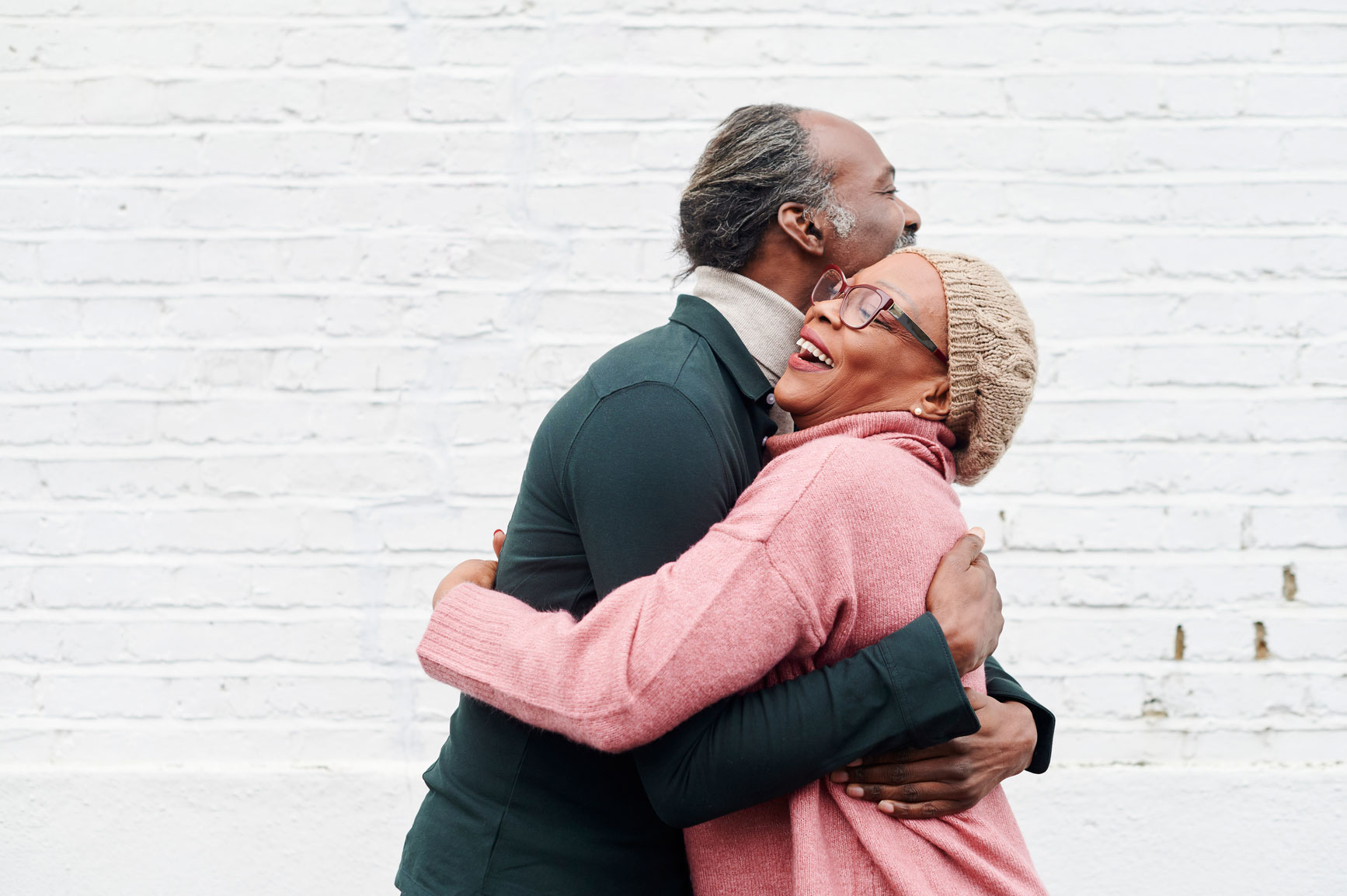 A couple shares a big, warm hug