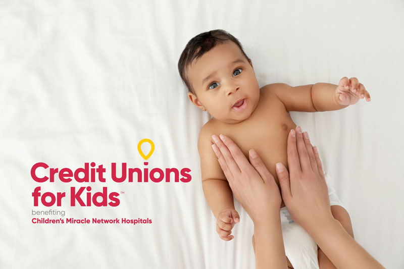 Photo of a baby in a diaper on a white background with the Credit Unions for Kids logo