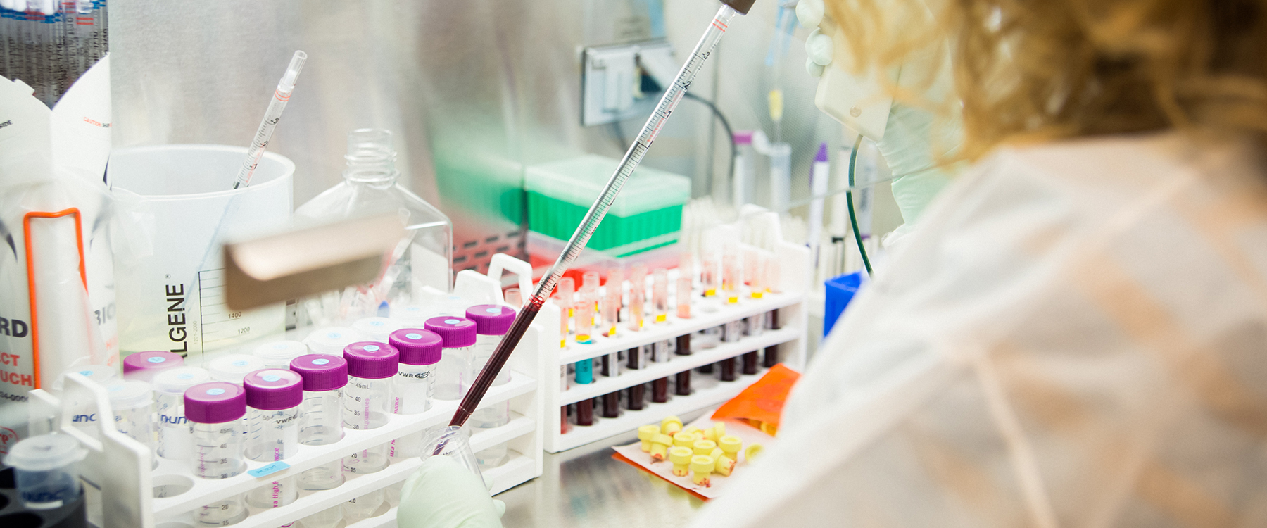 A person in a lab handling vials