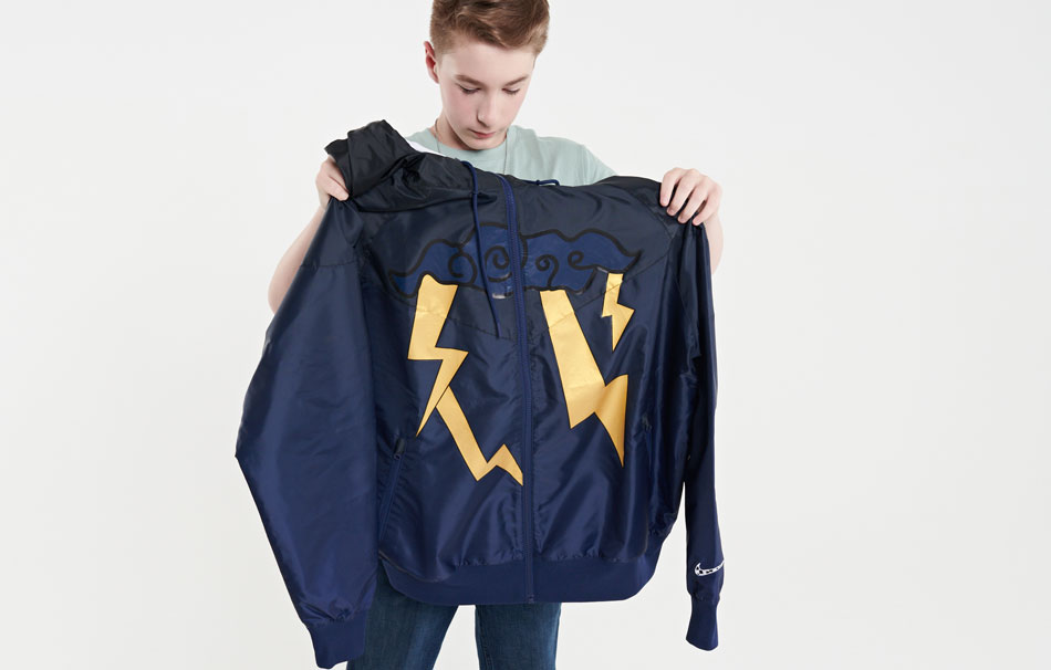 Garrett shows off his Freestyle jacket, which is navy with a blue cloud and gold lightning bolts