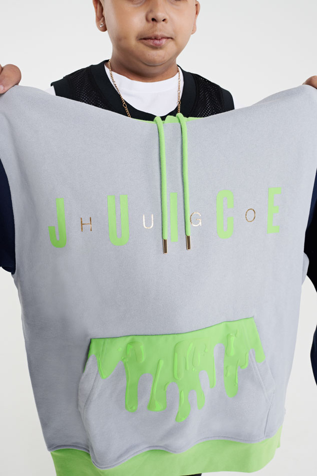 Hugo's hoody sweatshirt is gray with black arms and alternating green and lettering that says HUGO and JUICE. Green juice appears to drip from the top of the pocket. 