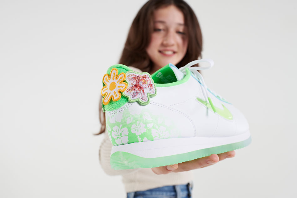 Close-up of the back of Sydney's shoe shows hibiscus flower and goldfish.