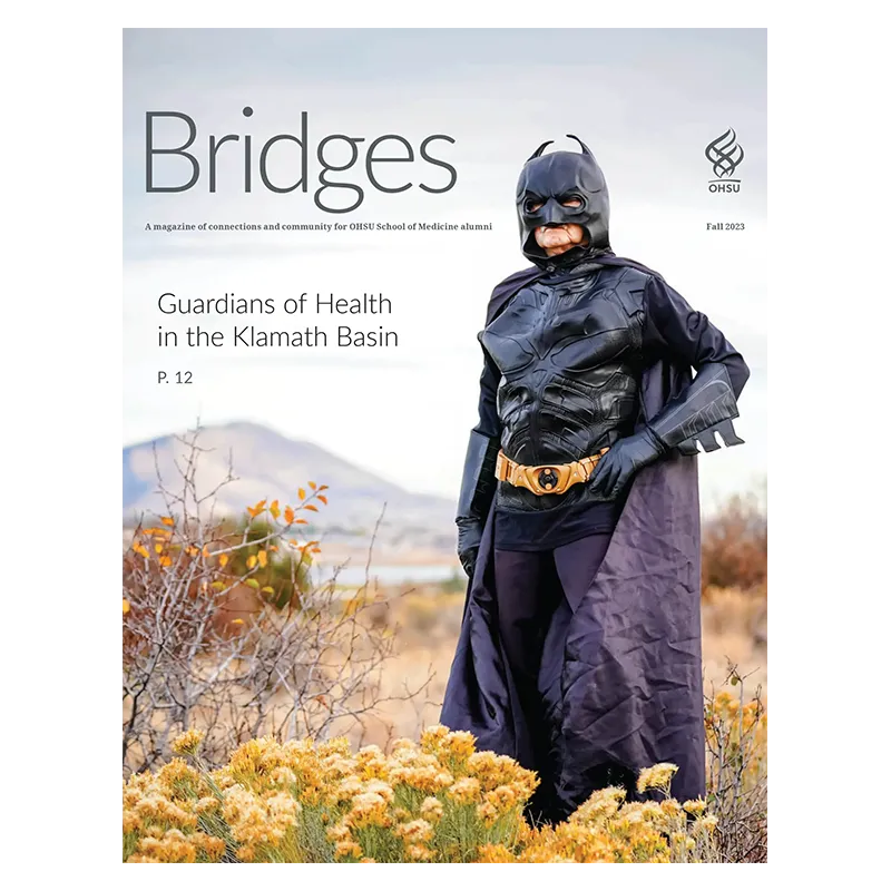 A magazine cover showing a man dressed in a Batman costume standing in a field next the title Bridges.