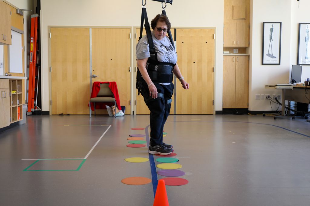 Linda Cherney navigates colorful obstacles on the floor.
