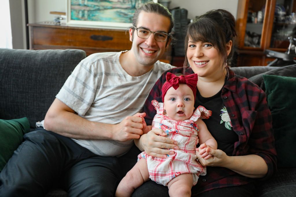 Gabrielle Zielinski sits with her husband and 4-month-old daughter.