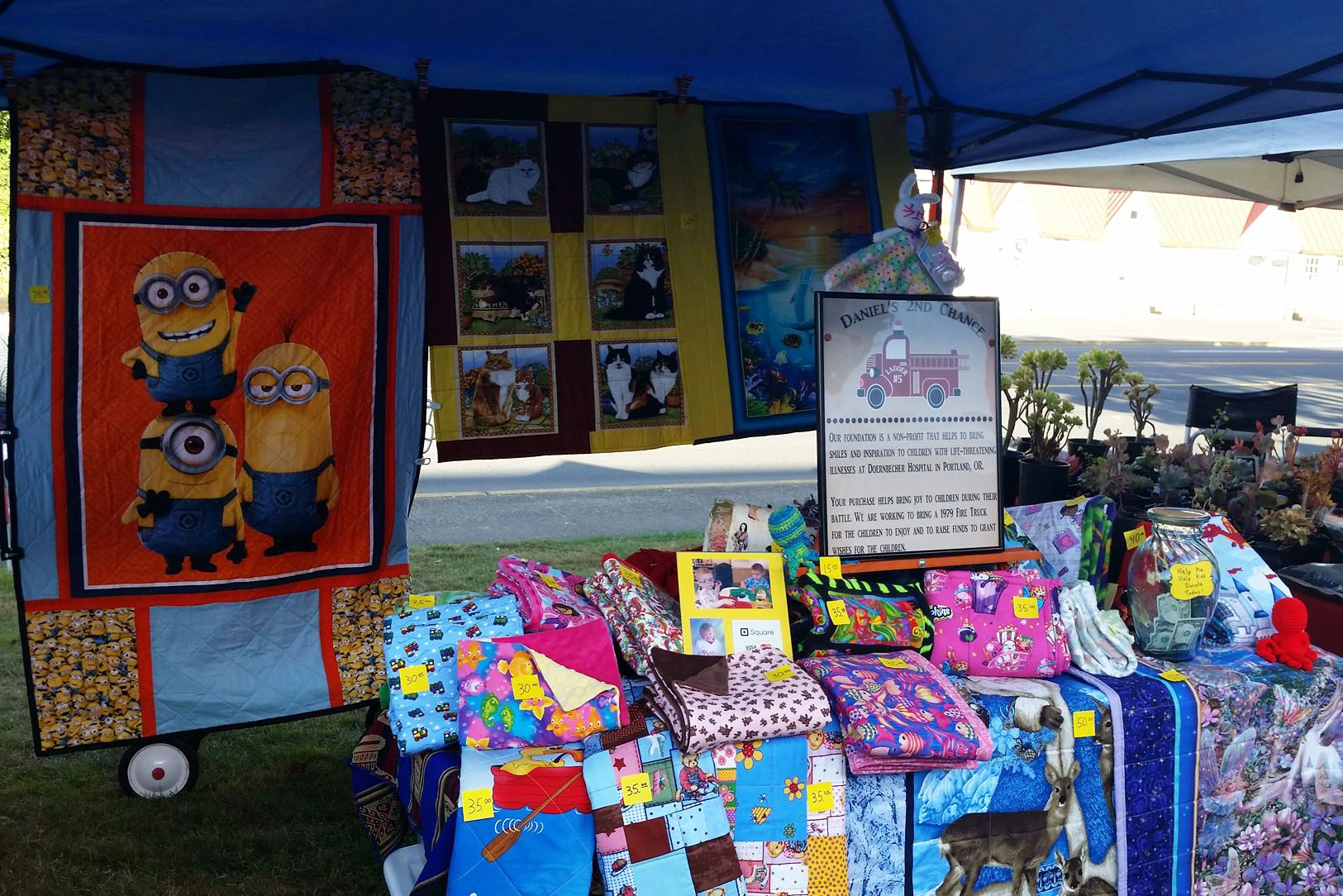Daniel's 2nd Chance booth with quilts for sale