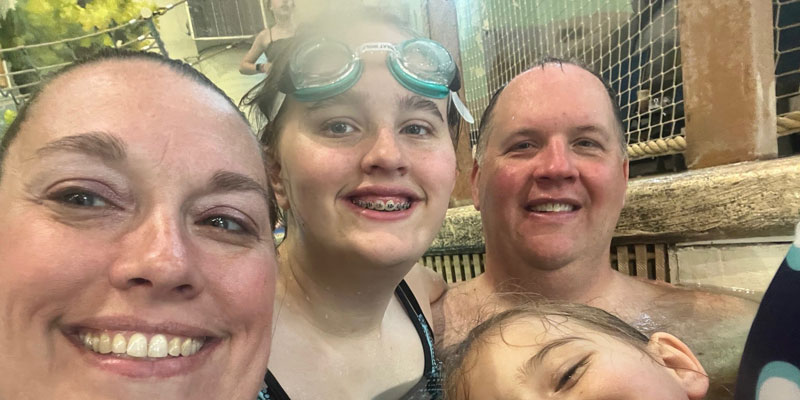 Abby Yoder with her family in a swimming pool