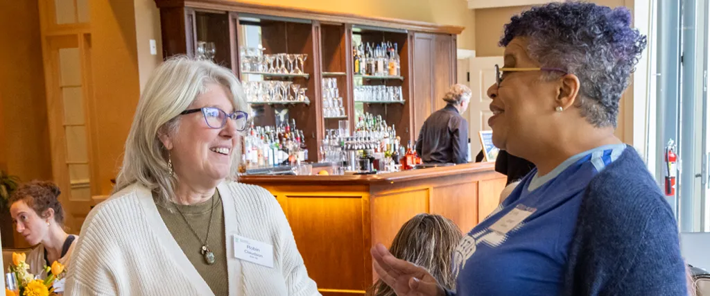 Two School of Nursing alumni vist during the alumni Soirée.