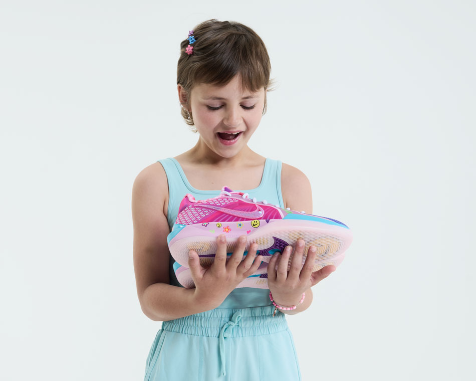 Sophia holds her Doernbecher Freestyle 20 shoe, her very own creation. 