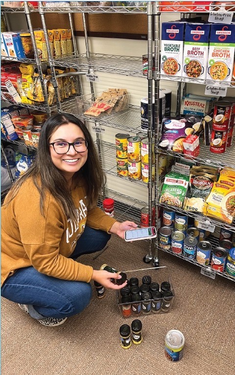 Alonzo Zamora restocking the student food pantry