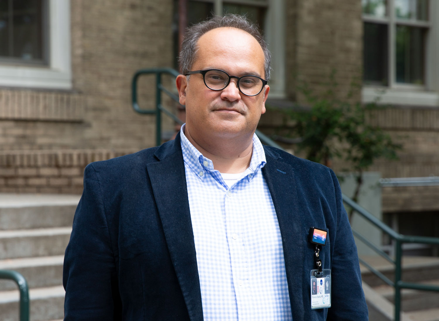 Flavio Rocha, M.D., stands outside a building at OHSU's Marquam Hill campus.