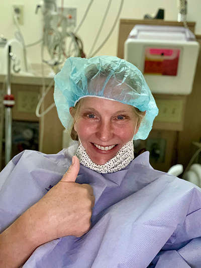 Carolyn Stanley gives a thumbs up before open-heart surgery.