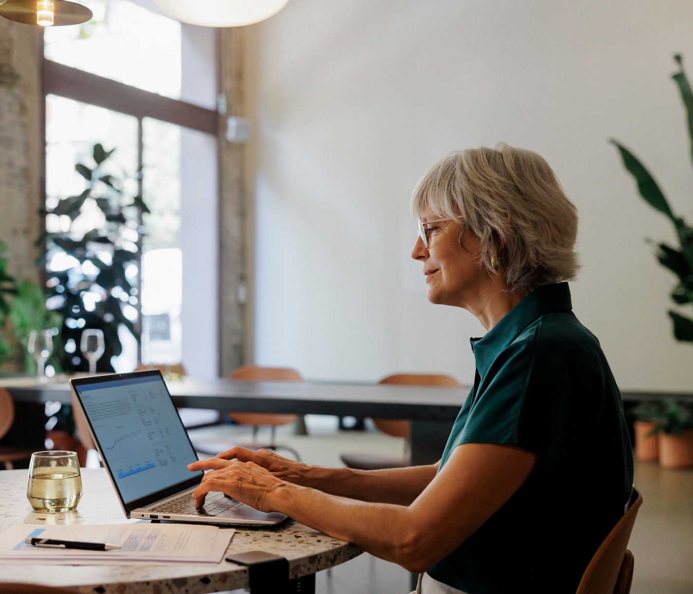 A woman working on her computer in a stylish cafe
