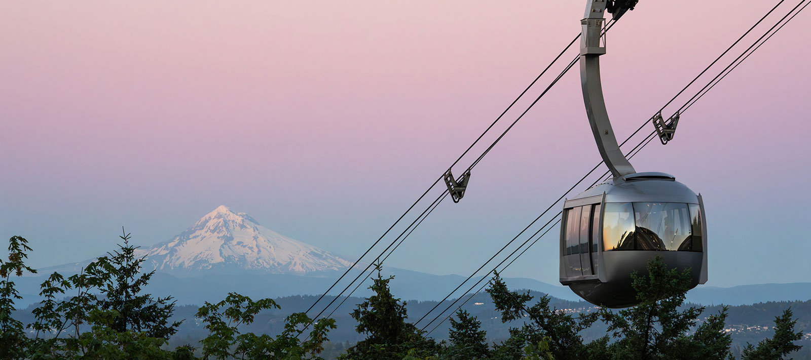 Portland Aerial Tram with Mt. Hood and a pink sky in the background