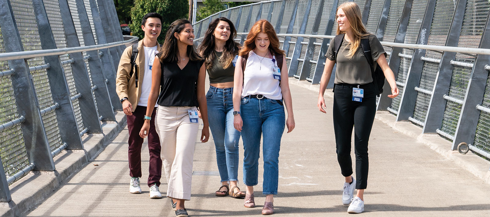 students walk across the Gibbs Street Pedestrian Bridge