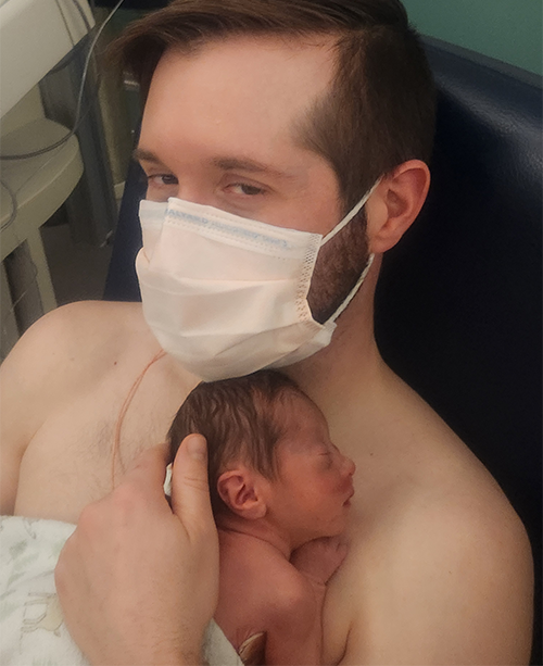 Nick Schoepp holds his newborn child, Zack, at OHSU.