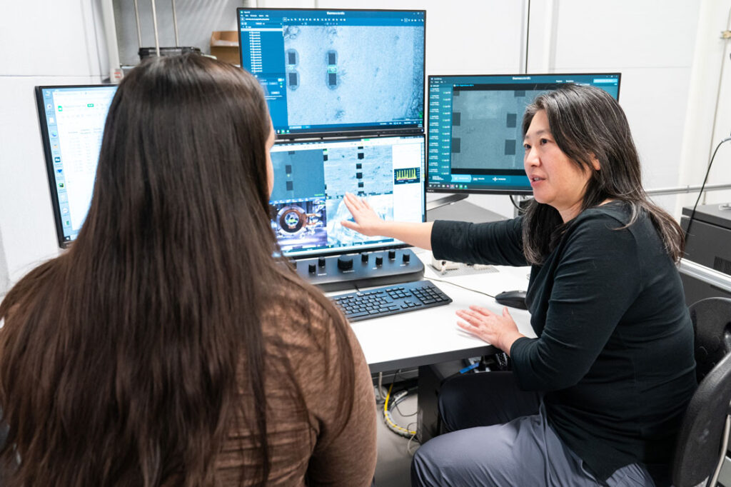 Aya Matsui, Ph.D., discusses cryo-electron tomography with research assistant Yaya Kiss