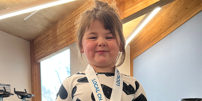 Izzy wearing a CMN champions medal