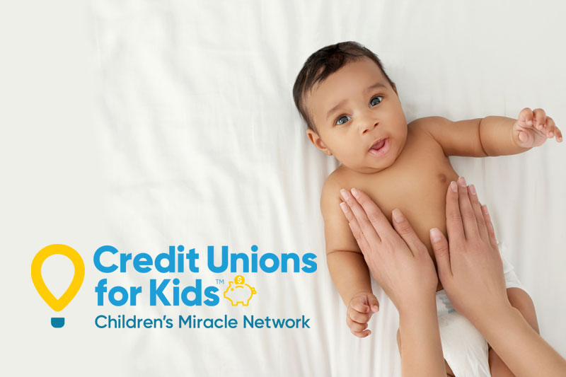 Photo of a baby with the Credit Unions for Kids logo