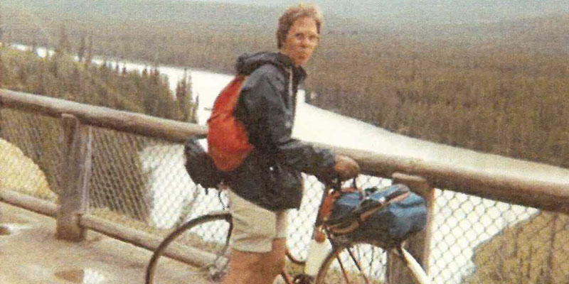 Family photo of Mary Anne Herron with her bicycle overlooking a lake