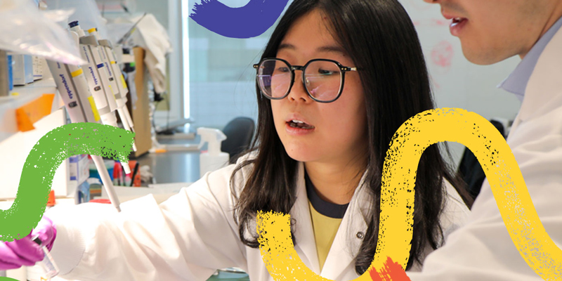 Two researchers working in a lab, with colorful squiggle shapes painted over the image