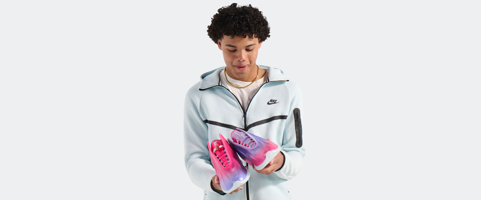 Kamoryn holds his Freestyle shoes for the first time