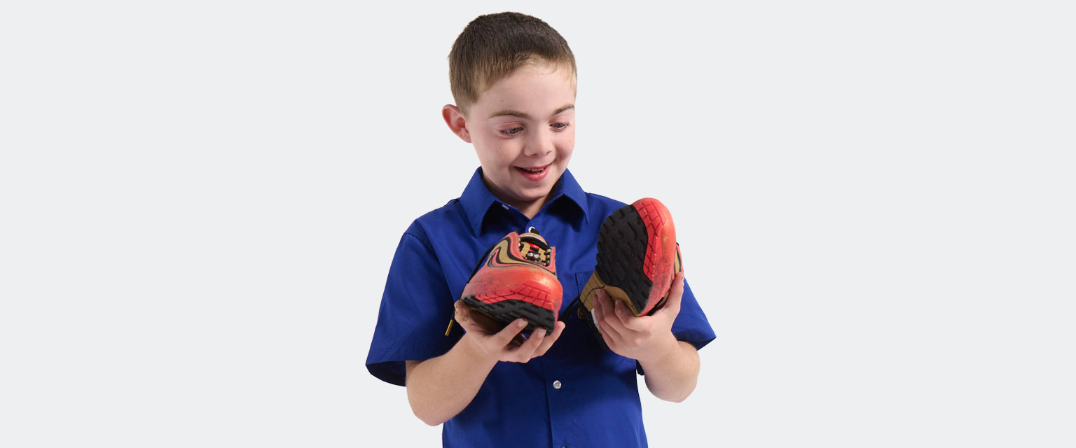 Owen holds his Freestyle shoes for the first time